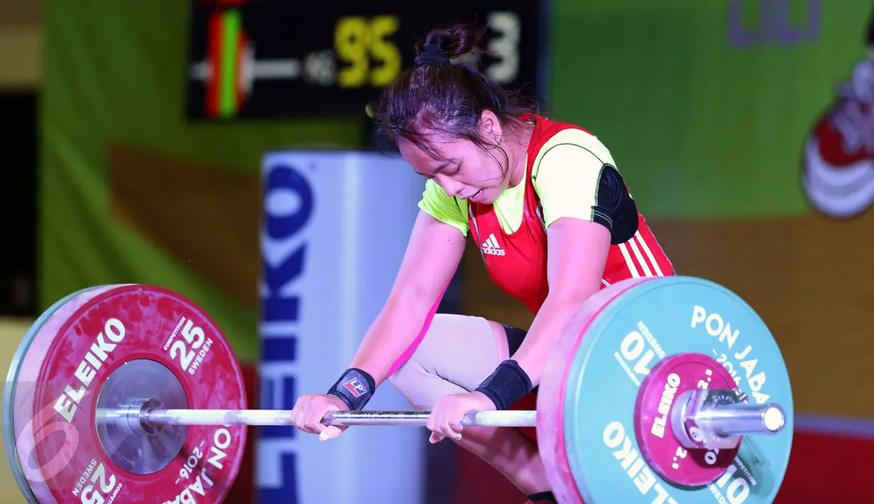 Lifter DKI Jakarta, Irma C Gusdarifah melakukan angkatan clean and jerk kelas 58kg PON XIX Jabar di Gymnasium Si Jalak Harupat, Kab Bandung, Rabu (21/9). Irma meraih perunggu dengan total angkatan 170kg. (Liputan6.com/Helmi Fithriansyah)
