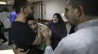 Anggota keluarga Palestina Abu Dayer menangis di rumah sakit Al-Shifa setelah kematian anggota keluarga dalam serangan udara Israel di Kota Gaza, Senin (17/5/2021). Tercatat ada 212 penduduk Jalur Gaza, Palestina yang kehilangan nyawa di antaranya 61 korban merupakan anak-anak. (MAHMUD HAMS/AFP)