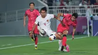 Pemain Timnas Indonesia U-23, Komang Teguh Trisnanda (kiri) berebut bola dengan pemain Korea Selatan U-23, Kim Dong-jin pada laga perempatfinal Piala Asia U-23 2024 di Abdullah bin Khalifa Stadium, Doha, Qatar, Jumat (26/4/2024) dini hari WIB. (Dok. PSSI)