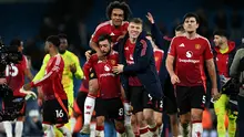 Pemain Manchester United, Bruno Fernandes (kedua kiri) bersama Joshua Zirkzee (tengah) dan Rasmus Hojlund (kedua kanan) melakukan selebrasi usai pertandingan sepak bola Liga Premier Inggris melawan Manchester City di Stadion Etihad, Manchester, Inggris, pada 15 Desember 2024. (Paul ELLIS/AFP)