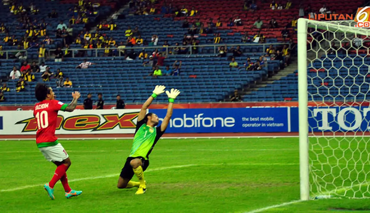 Pemain depan Timnas Indonesia, Irfan Bachdim berhadapan dengan kiper Laos Sengphachan Bounthisanh dalam laga Piala AFF Suzuki 2012, di Stadion Bukit Jalil, Kuala Lumpur, Malaysia. Kamis, 25/11/2012. Pertandingan Berakhir seri 2-2.