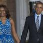 Presiden Amerika Serikat (AS) ke-44, Barack Obama menggandeng tangan sang istri, Michelle Obama, sambil menyapa awak media setibanya pada acara parade di barak marinir AS, Washington, 27 Juni 2014. (AFP PHOTO / SAUL LOEB)