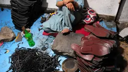 Seorang pembuat sepatu asal Pakistan beristirahat setelah membuat sepatu tradisional yang dikenal sebagai "chapli" di kalangan penduduk lokal untuk menyambut Hari Raya Idul Fitri di Peshawar, Pakistan barat laut, pada 19 Mei 2020. (Xinhua/Saeed Ahmad)