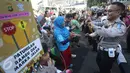 Petugas kepolisian bersama polisi cilik berjoged saat melakukan kampanye keselamatan berkendara di kawasan Bundaran HI, Jakarta, Minggu (12/3). (Liputan6.com/Immanuel Antonius)
