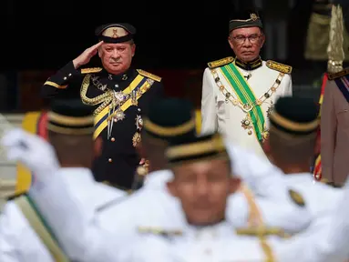 Raja Malaysia ke-17, Sultan Ibrahim Sultan Iskandar dari Johor memberi hormat kepada penjaga kehormatan, di samping Perdana Menteri Malaysia Anwar Ibrahim di Istana Nasional di Kuala Lumpur pada tanggal 31 Januari 2024. (HASNOOR HUSSAIN/POOL/AFP)