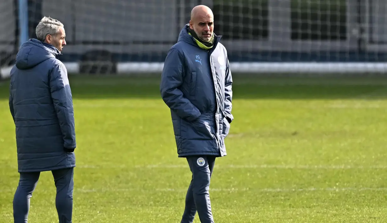 Pelatih Manchester City, Pep Guardiola mengatakan meskipun peluang menang di Santiago Bernabeu sangat kecil, namun ia memastikan timnya tetap berkomitmen berjuang keras demi meraih kemenangan. (Paul ELLIS/AFP)