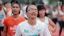 Ekspresi pelari saat mencapai garis finis dalam Jakarta Marathon 2018 di Gelora Bung Karno, Jakarta, Minggu (28/10). 12.500 pelari meramaikan Jakarta Marathon 2018, Memasuki tahun keenam, Jakarta Marathon yang di sponsori PLN. (Liputan6.com/Faizal Fanani)