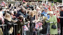 Ratu Inggris Elizabeth II menerima bunga dari warga saat merayakan ulang tahunnya yang ke-90  di kawasan Istana Windsor, Berkshire, Inggris (21/4/2016). (AFP PHOTO/John Stillwell)