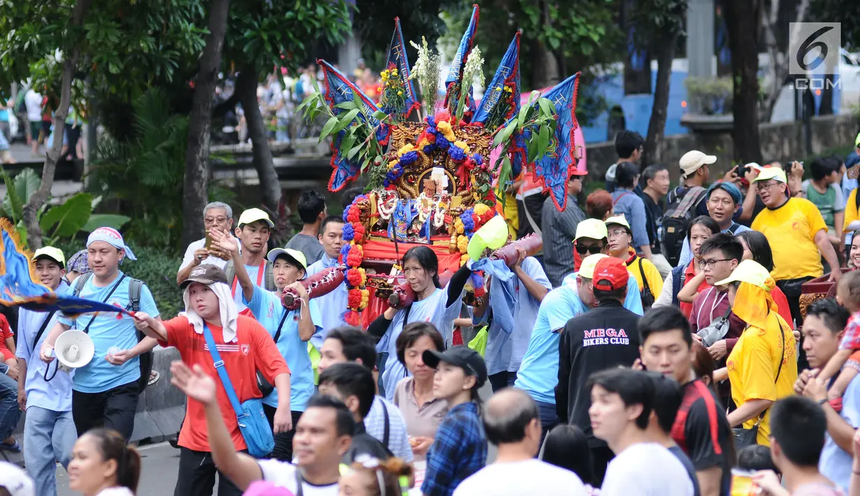 Iring-iringan patung dewa melintas saat karnaval Cap Go Meh 2018 di Jalan Gajah Mada, Jakarta, Minggu (4/3). Beragam atraksi budaya ditampilkan dalam karnaval perayaan Cap Go Meh 2018 di kawasan Glodok Jakarta. (Liputan6.com/Helmi Fithriansyah)