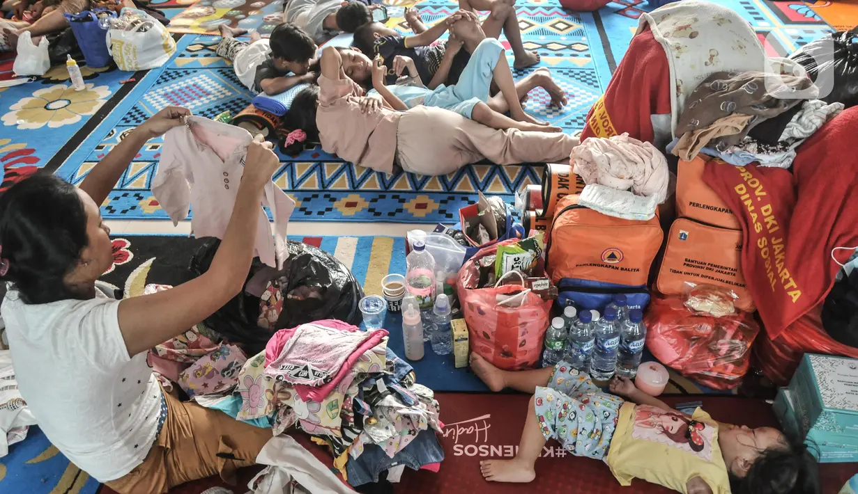 Warga korban kebakaran memilah pakaian yang didapat dari bantuan sosial di Kantor Kelurahan Jembatan Lima, Tambora, Jakarta Barat, Rabu (27/7/2022). Kebakaran yang terjadi pada Selasa (26/7/2022) dini hari tersebut sedikitnya menghanguskan 48 rumah di RT 04 dan 05, RW 08 Kelurahan Jembatan Lima dan memaksa 75 KK yang terdiri atas 300 jiwa kehilangan tempat tinggal. (merdeka.com/Iqbal S Nugroho)