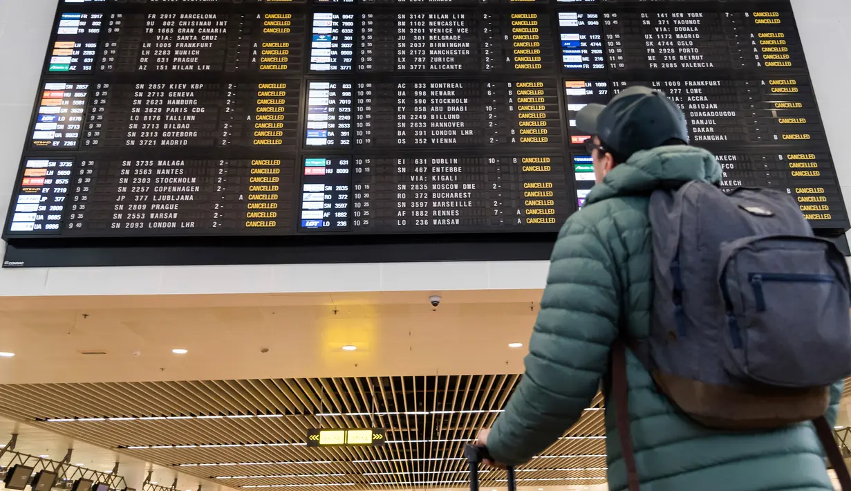 Penumpang berjalan di aula keberangakatan di Bandara Brussels, Zaventem, Belgia, Rabu (13/2). Tidak ada pesawat yang terbang di bawah ketinggian 8.000 meter akan diizinkan terbang di atas negara itu. (AP Photo/Geert Vanden Wijngaert)