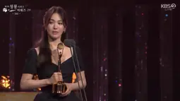 Song Hye Kyo memegang piala kemenangannya. Dia seolah masih masih mencerna keadaan, dia seakan tak percaya berhasil menyabet Daesang di salah satu ajang penghargaan bergengsi di Korea Selatan. (Foto: KBS2 via Twitter)