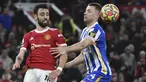 Gelandang Manchester United (MU) Bruno Fernandes berebut bola dengan bek Brighton & Hove Albion Adam Webster pada laga pekan ke-18 Liga Inggris di Old Trafford, Rabu dini hari WIB (16/2/2022). MU menang dengan skor meyakinkan 2-0. (AP Photo/Rui Vieira)
