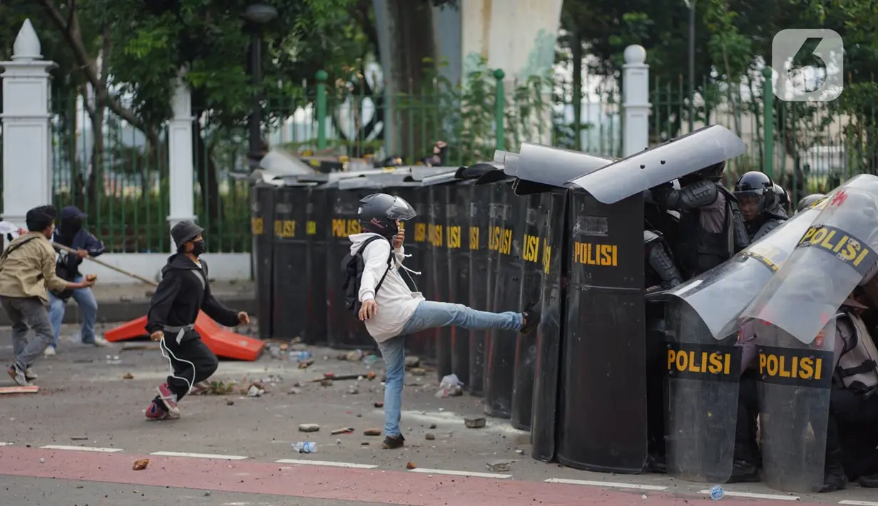 Pengunjuk rasa terlibat bentrok dengan polisi di Jalan Medan Merdeka Timur, Jakarta, Kamis (8/10/2020). Bentrokan terjadi akibat massa yang memaksa masuk ke depan Istana Negara untuk berunjuk rasa terkait penolakan UU Cipta Kerja. (Liputan6.com/Immanuel Antonius)