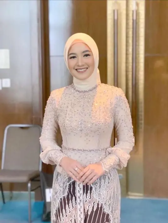 Cut Syifa mengenakan kebaya modern warna nude yang dihiasi dengan payet berkilauan. Ia juga memakai hijab warna senada, bawahan batik, dan sepasang sepatu high heels. [Instagram/cutsyifaa]