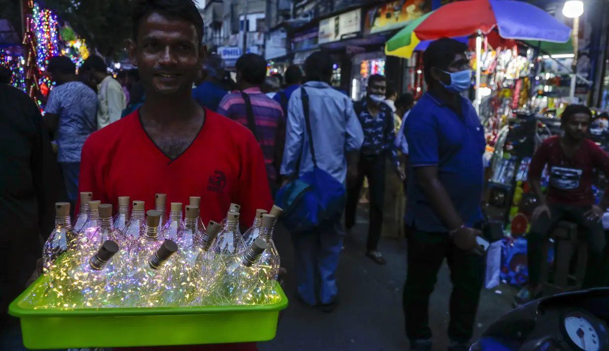 Seorang pedagang menjual lampu hias di jalan menjelang Diwali, festival lampu Hindu, di Kolkata, India, Rabu (27/10/2021). Diwali, festival lampu, dirayakan pada 4 November. (AP Photo/Bikas Das)