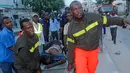 Petugas mengevakuasi korban serangan bom mobil di Mogadishu, Somalia (8/5). Setidaknya 6 orang tewas dan 10 orang lainnya terluka dalam serangan bom mobil tersebut. (AP Photo/Farah Abdi Warsameh)
