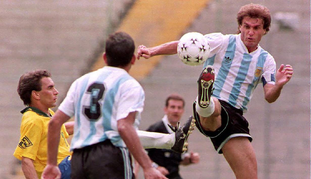 Oscar Ruggeri. Eks bek tengah berusia 60 tahun yang pensiun pada Januari 1998 bersama Lanus ini tercatat total mengoleksi 16 caps bersama Argentina di ajang Piala Dunia. Jumlah tersebut dicatatkannya dalam 3 edisi Piala Dunia, yaitu mulai 1986 hingga 1994. Prestasi terbaiknya saat membawa Argntina menjadi juara pada edisi 1986 di Meksiko setelah menang 3-2 atas Jerman di partai final. (AFP/Daniel Garcia)