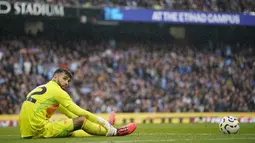 Kiper Arsenal, David Raya, tampak lesu setelah gawangnya dibobol pemain Manchester City, John Stones, pada laga Liga Inggris di Stadion Etihad, Minggu (22/09/2024). (AP Photo/Dave Thompson)