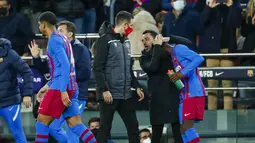 Penyerang Barcelona, Ousmane Dembele (kanan) diberi selamat oleh pelatihnya Xavi setelah mencetak gol ke gawang Athletic Bilbao selama pertandingan lanjutan La Liga Spanyol di di stadion Camp Nou di Barcelona, Spanyol, Senin (28/2/2022). Barcelona menang telak atas Atletico Bilbao 4-0. (AP Photo/Joa