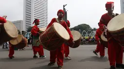 Seniman cilik memainkan alat musik tambur khas Minangkabau saat car free day (CFD) di Jakarta, Minggu (13/1). Pertunjukan ini juga sekaligus untuk mengenalkan keberagaman budaya Nusantara. (Liputan6.com/Angga Yuniar)