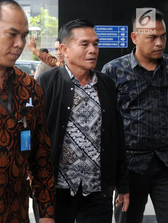 Bupati Bengkulu Selatan Dirwan Mahmud (tengah) dikawal petugas menuju gedung KPK usai terjaring Orasi Tangkap Tangan (OTT), Jakarta (15/5). KPK menyita Rp 100 juta dalam operasi tersebut. (Merdeka.com/Dwi Narwoko)