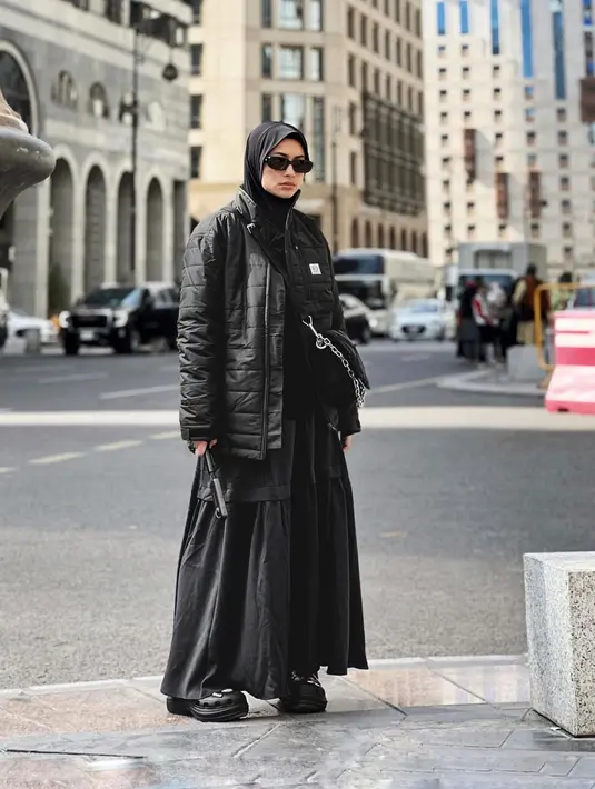 Tampil all black, Sintya Marisca kenakan puffy jacket dengan ruffle skirt panjang dan crocs. Ia pun menutup penampilan dengan hijab instan dan sling bag [@sintyamarisca]