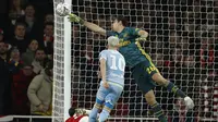 Kiper Arsenal Emiliano Martinez jatuh bangun meredam serangan Leeds United pada laga babak ketiga Piala FA di Emirates Stadium, Senin (6/1/2020) atau Selasa dini hari WIB. (AFP/Adrian Dennis)