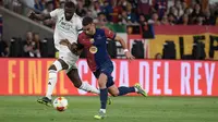 Bek Real Madrid asal Jerman #22, Antonio Rudiger (kiri), dan penyerang Barcelona asal Spanyol #07, Ferran Torres, berebut bola selama pertandingan final Piala Spanyol, Copa del Rey (Piala Raja) antara FC Barcelona dan Real Madrid CF di stadion La Cartuja di Seville, Minggu dini hari WIB (27-4-2025). (Josep LAGO/AFP)