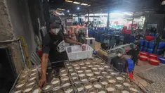 Pekerja menyelesaikan pembuatan kue keranjang di Pabrik Kue Hoki di kawasan Sawangan, Depok, Jawa Barat, Selasa (21/1/2025). (merdeka.com/Arie Basuki)