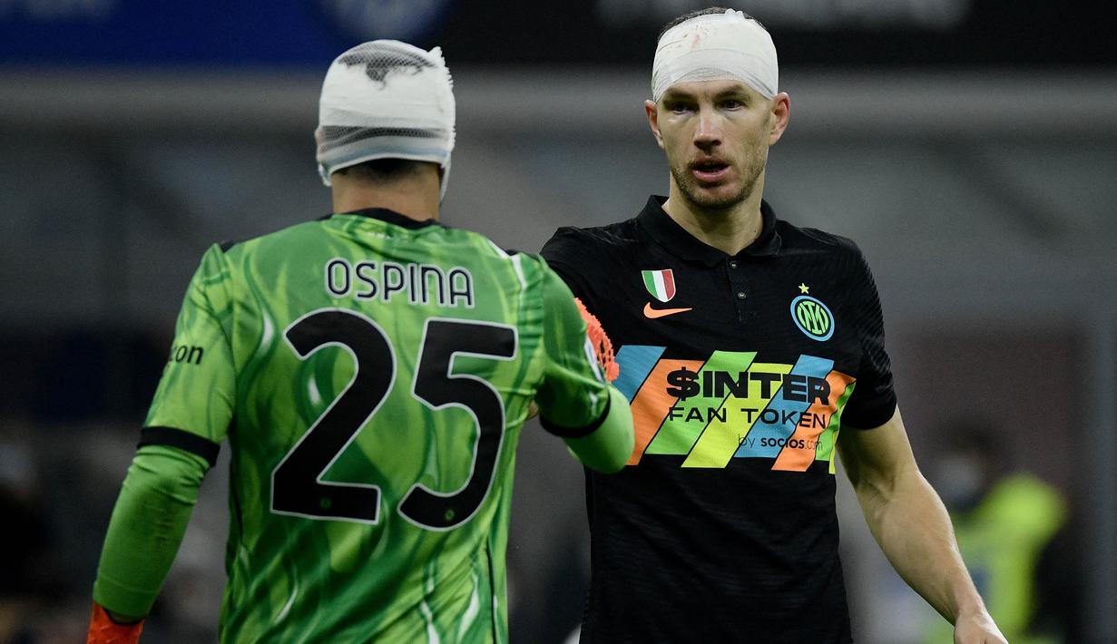 Duel sengit terjadi saat Inter Milan melawan Napoli. Kerasnya pertandingan membuat Edin Dzeko yang sempat berebut bola diudara dengan David Ospina membuat keduanya harus memakai perban dikepala. (AFP/Filippo Monteforte)