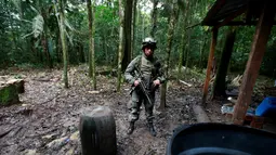 Polisi antinarkotika Kolombia berjaga saat menemukan laboratorium pembuatan kokain di tengah hutan, Desa Calamar, Guaviare, Kolombia, Selasa (2/8). Polisi mengaku sudah memusnahkan 104 pabrik kokain dalam operasi 5 hari.(REUTERS/John Vizcaino)