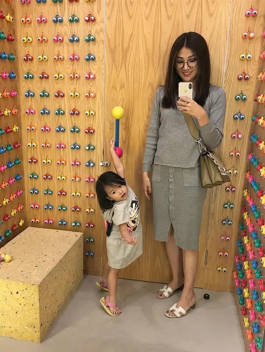 Masih terlihas simple, Sarwendah hanya memakai skirt berwarna abu-abu dan atasannya yang berwarna senada. Lalu ia hanya memakai sandal dan tas selempang, terlebih rambutnya yang dibiarkan terurai gitu saja. (Instagram/Sarwendah29)