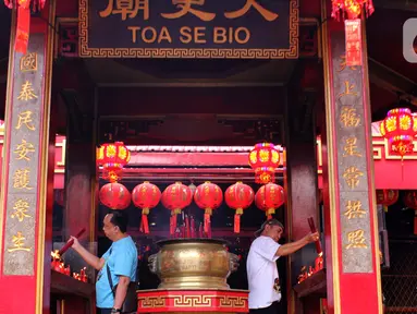 Beberapa warga menyalakan hio di Vihara Dharma Jaya atau Klenteng Toasebio di Jalan Kemenangan III, Kawasan Petak Sembilan, Jakarta, Senin (20/1/2025). (Magang/Liputan6.com/Muhammad Rizal)