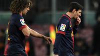  Carlos Puyol - Lionel Messi AFP PHOTO / LLUIS GENE