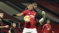 Striker Manchester United, Anthony Martial (depan) berebut bola dengan bek Real Sociedad, Modibo Sagnan dalam laga leg kedua babak 32 Besar Liga Europa 2020/21 di Old Trafford Stadium, Kamis (25/2/2021). Manchester United bermain imbang 0-0 dengan Real Sociedad. (AP/Dave Thompson)