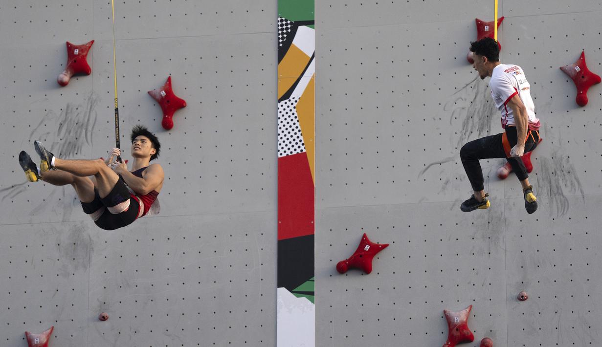 Atlet panjat tebing Indonesia, Veddriq Leonardo (kanan) melakukan selebrasi setelah menang cepat atas wakil China, Wu Peng dalam ajang Kualifikasi Olimpiade 2024 panjat tebing nomor speed di Shanghai, China, Sabtu (18/05/2024) waktu setempat. (AP Photo/Ng Han Guan)