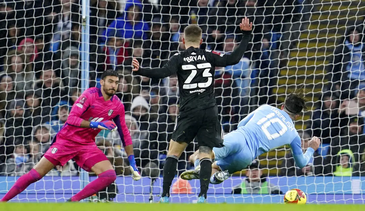 Pemain Fulham Joe Bryan melanggar pemain Manchester City Jack Grealish (kanan) yang menghasilkan tendangan penalti pada pertandingan sepak bola putaran keempat Piala FA di Etihad Stadium, Manchester, Inggris, 5 Februari 2022. Manchester City menang 4-1. (AP Photo/Jon Super)