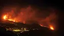 Lava dari gunung berapi mencapai laut di pulau Canary La Palma, Spanyol, Rabu (29/9/2021) dinihari. Lava merah panas dari gunung berapi Cumbre Vieja mencapai Samudra Atlantik, sembilan hari setelah mulai mengalir menuruni gunung. (AP Photo/Daniel Roca)