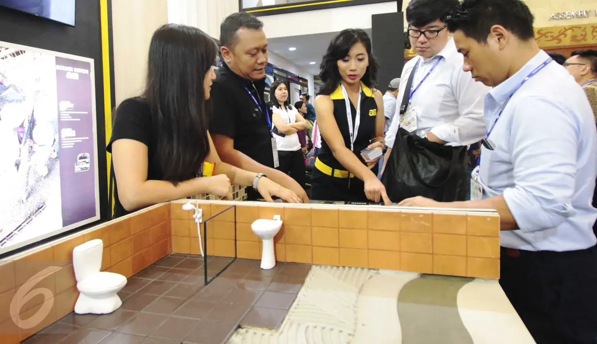 Karyawan AM memperlihatkan kinerja AM 77 dan 78 saat pameran di JCC Senayan Jakarta, Jumat (18/3/2016). AM 77 dan 78 berfungsi untuk meningkatkan initial time sehingga beton tidak cepat beku dan meningkatkan kuat tekan beton (Liputan6.com/Angga Yuniar)