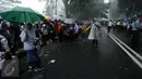 Sejumlah pelajar SD bermain hujan usai menyambut kedatangan Raja Salman di sekitar Istana Bogor, Rabu (1/3). Kedatangan Raja Salman bin Abdulaziz ke Istana Bogor disambut puluhan ribu pelajar dan warga. (Liputan6.com/Helmi Fithriansyah) 