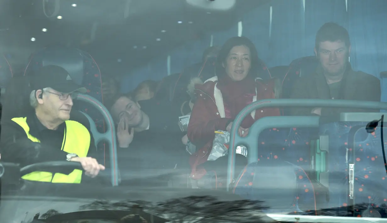 Warga negara Inggris berada di dalam bus meninggalkan Rumah Sakit Arrowe Park setelah di Wirral, Liverpool (13/2/2020). 83 warga negara Inggris yang dipulangkan dari Wuhan, China di tengah wabah coronavirus COVID-19 dapat meninggalkan rumah sakit setelah dikarantina dua minggu.(AFP Photo/Oli Scarff)