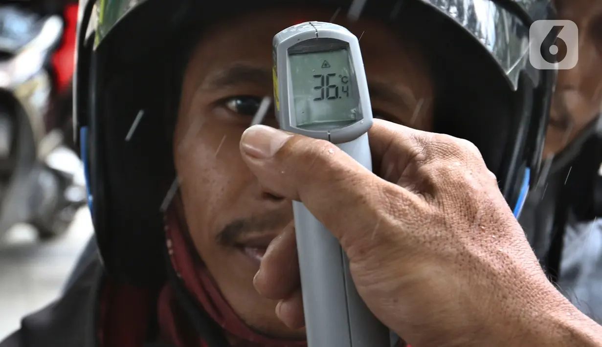 Pengendara sepeda motor menjalani pengecekan suhu tubuh saat akan masuk Kompleks Parlemen di Senayan, Jakarta, Kamis (5/3/2020). Pengecekan dilakukan sebagai tindakan preventif terkait penyebaran virus corona (COVID-19) setelah dua WNI dinyatakan positif terinfeksi. (Liputan6.com/Johan Tallo)