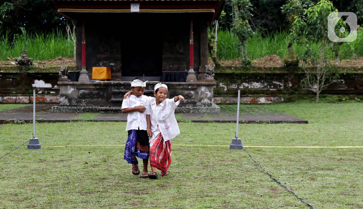 Usai mengikuti upacara peringatan detik-detik Proklamasi di halaman Tugu Pahlawan Banjar Penglipuran, Kabupaten Bangli, Bali, anak-anak terlihat ceria bermain, Kamis (17/8/2023). (Liputan6.com/Helmi Fithriansyah)