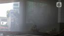 Petugas berusaha memadamkan kebakaran di Gedung Cyber 1, Jakarta, Kamis (2/12/2021). Suku Dinas Pemadam Kebakaran DKI Jakarta menurunkan 22 unit mobil pemadam kebakaran. (Liputan6.com/Herman Zakharia)