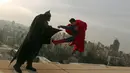 Dua orang pria mengenakan kostum Batman dan Superman melakukan adegan bertarung saat sesi pemotretan di Lebanon (23/3). Film terbaru dari Batman vs Superman telah ditayangkan dibeberapa bioskop dunia. (PATRICK BAZ / AFP)