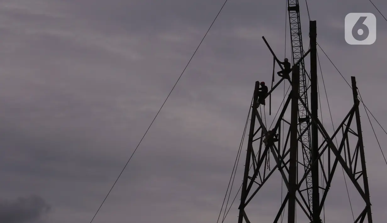 Pekerja tengah melakukan aktivitas kerja pada ketinggian di menara sutet di kawasan Karang Tengah, Kota Tangerang, Banten, Jumat (8/1/2021). Sebanyak  4.275 kasus kecacatan, 9 kasus cacat total tetap dan 2002 kasus meninggal dunia sampai Oktober tahun 2020. (Liputan6.com/Angga Yuniar)