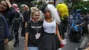 Seorang anggota komunitas LGBT berfoto bersama seorang pendukung gerakan pro-demokrasi saat unjuk rasa di kawasan bisnis Ratchaprasong di Bangkok, Thailand, Minggu (25/10/2020). (AP Photo/Gemunu Amarasinghe)