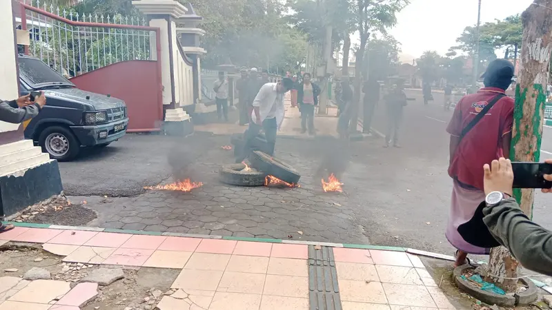 Massa membakar ban menolak penundaan pilkades Pamekasan. (Istimewa)