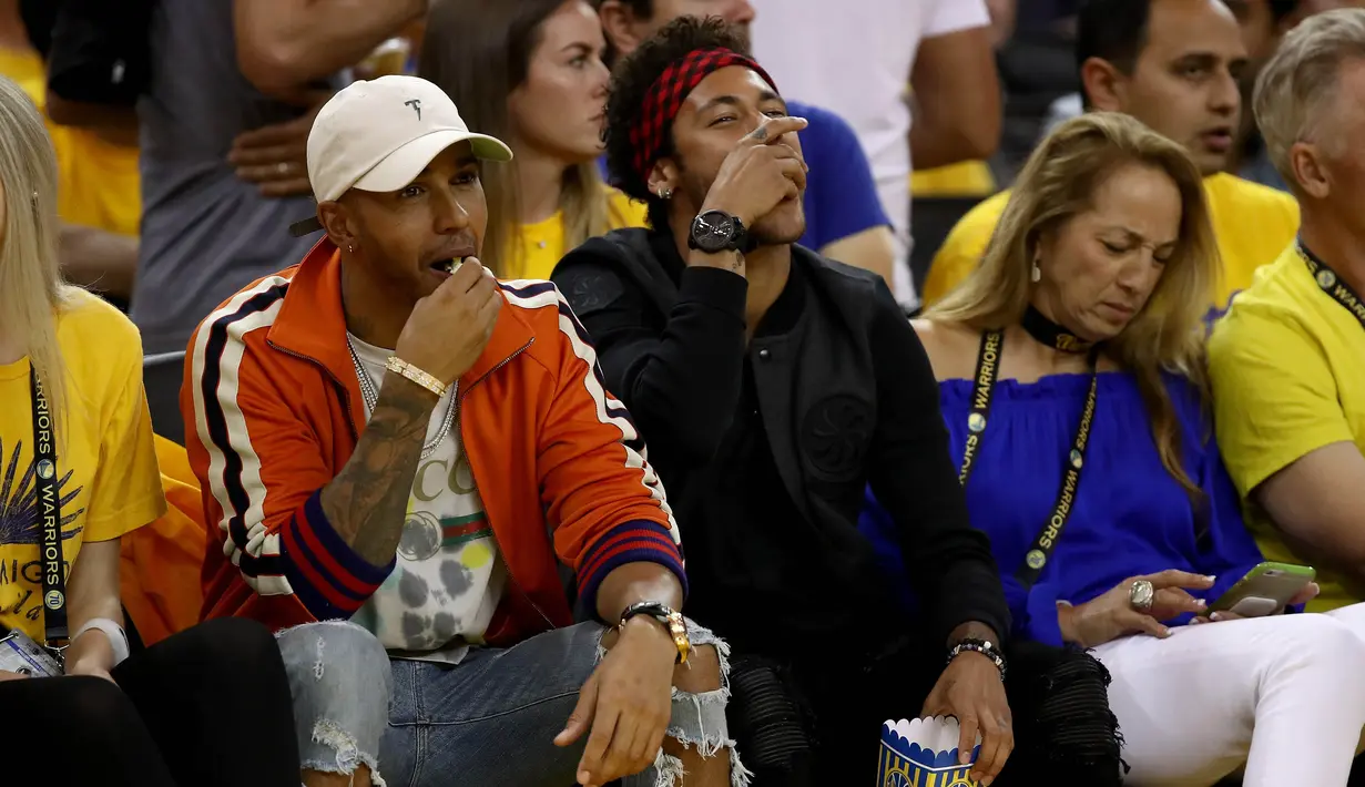 Pembalap F1, Lewis Hamilton dan Striker Barcelona, Neymar Jr menyaksikan gim kedua Final NBA antara Cleveland Cavaliers melawan Golden State Warriors di Oracle Arena, California, (4/06/2017). Golden State Warriors menang 132-113. (AFP/Ezra Shaw)